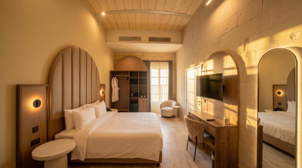 Suite with a smart TV and a sitting area at St Anne Palace, Floriana, Malta