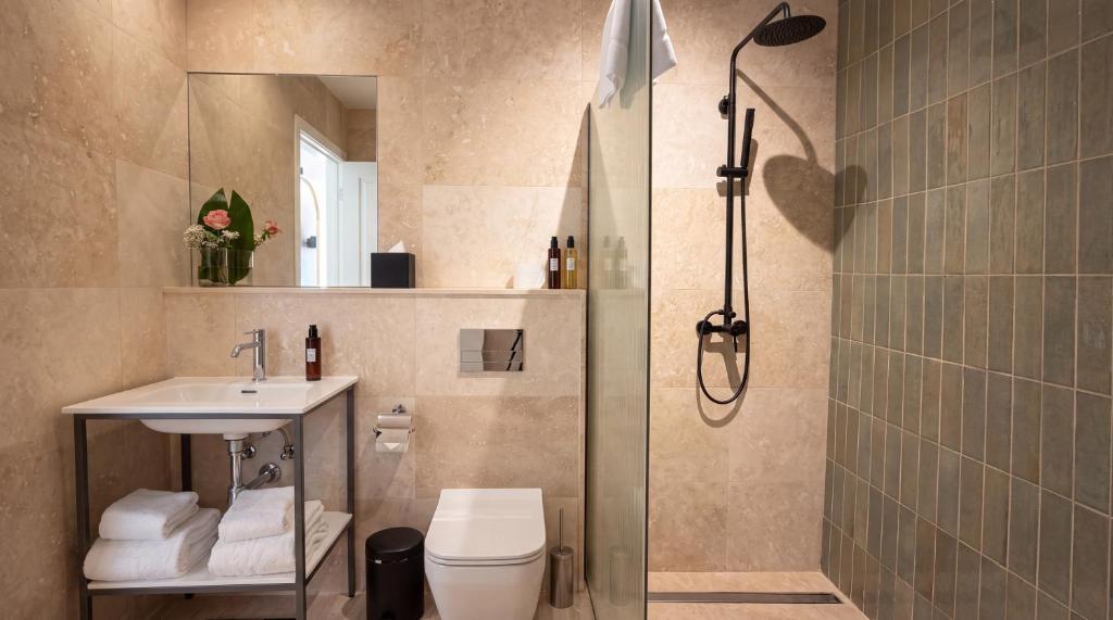 Ensuite bathroom with a vanity and a walk-in shower at St Anne Palace, Floriana, Malta